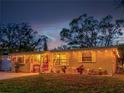 Attractive single-story home with charming landscaping at dusk at 6145 55Th N Ave, St Petersburg, FL 33709