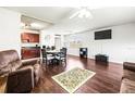 Open living and dining space with kitchen, dark brown furniture, and hardwood floors at 1801 Bedford Ln # 27, Sun City Center, FL 33573