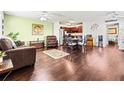 Living room with dark brown leather furniture and hardwood floors at 1801 Bedford Ln # 27, Sun City Center, FL 33573