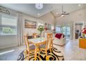 Bright dining area with glass table and access to the living room at 2001 Palm Key Ave, Oldsmar, FL 34677