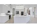 Bright, white kitchen with quartz countertops, modern appliances, and stylish pendant lighting at 7925 Royal Queensland Way, Lakewood Ranch, FL 34202