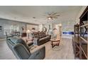 Open-concept living area featuring a modern fireplace and comfortable seating at 5521 Limelight Dr, Apollo Beach, FL 33572