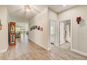 Bright and spacious hallway with wood-look tile flooring and access to living areas at 5521 Limelight Dr, Apollo Beach, FL 33572