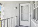 Exterior view of unit entrance with storm door at 12049 Hoosier Ct # 202, Hudson, FL 34667