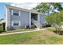 Two-story building exterior with walkway and landscaping at 12049 Hoosier Ct # 202, Hudson, FL 34667
