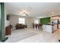 Open living and kitchen area with modern finishes at 10348 Blue Plume Ct, Riverview, FL 33578