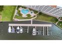 Aerial view showcases waterfront condo building with manicured grounds, pool, and boat docks, providing direct water access at 17745 Gulf Blvd # 604, Redington Shores, FL 33708