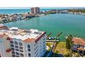 A back exterior shot of the condo building showcasing the boat lift and dock at 17745 Gulf Blvd # 604, Redington Shores, FL 33708