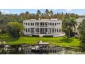 Backyard of a waterfront home featuring a pool, dock, and lush greenery at 2905 Safe Harbor Dr, Tampa, FL 33618