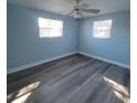 Bright bedroom with ceiling fan and gray laminate flooring at 3751 67Th N Ave, Pinellas Park, FL 33781