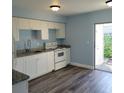 Renovated kitchen with white shaker cabinets and granite countertops at 3751 67Th N Ave, Pinellas Park, FL 33781