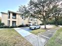 Condo building exterior with parking and landscaping at 5125 Palm Springs Blvd # 10110, Tampa, FL 33647