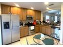 Kitchen with stainless steel appliances and wood cabinets at 18833 Bent Pine Dr, Hudson, FL 34667