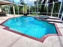Relaxing pool with a spa and brick coping at 10411 Riverburn Dr, Tampa, FL 33647