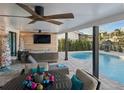 Covered patio with seating area overlooking a sparkling pool at 1367 51St Ne Ave, St Petersburg, FL 33703