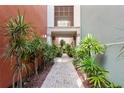 Peaceful inner courtyard with brick pathway and tropical plants at 2411 W Horatio St # 522, Tampa, FL 33609