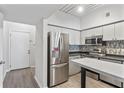 Modern kitchen with stainless steel appliances and light wood flooring at 2411 W Horatio St # 522, Tampa, FL 33609