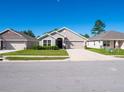 Newly built home with neutral colors and landscaping at 13291 Gulf Bay Ln, Spring Hill, FL 34609