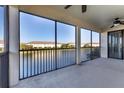 Large screened balcony with lake view and ceiling fan at 20180 Ragazza Cir # 201, Venice, FL 34293