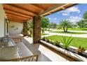 Covered porch with stone pillars and seating at 2115 Belmar Dr, Belleair Bluffs, FL 33770