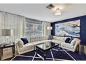 Bright living room with white sectional sofa and blue rug at 3063 E Dorchester Dr, Palm Harbor, FL 34684