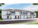 New townhouses with attached garages and neutral exterior at 469 Mangrove Shade Cir, Apollo Beach, FL 33572