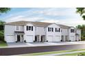 Modern gray townhome with two-car garage at 467 Mangrove Shade Cir, Apollo Beach, FL 33572