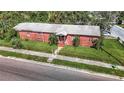 Aerial view of a brick home with a spacious yard and street parking at 3420 E 21St Ave, Tampa, FL 33605