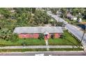 Aerial view of a brick home with a spacious yard and street parking at 3420 E 21St Ave, Tampa, FL 33605