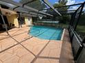 Screened-in pool with tiled deck at 4172 Glade Rd, Spring Hill, FL 34606