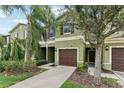 Green townhome with brown garage doors at 2622 Lantern Hill Ave, Brandon, FL 33511