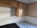 Kitchen area with white subway tile backsplash and oak cabinets at 1811 Michigan Ne Ave, St Petersburg, FL 33703