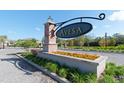 Community entrance with brick pillars and flower bed at 10038 Corso Milano Dr, Tampa, FL 33625