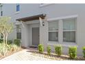House exterior with gray door and brick walkway at 10038 Corso Milano Dr, Tampa, FL 33625
