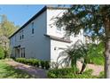 Two-story house with gray siding and brick walkway at 10038 Corso Milano Dr, Tampa, FL 33625