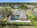 Expansive backyard with screened pool and patio furniture, complemented by lush landscaping at 14173 Pullman Dr, Spring Hill, FL 34609