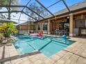 Inviting screened-in pool featuring a brick surround and covered outdoor dining space at 14173 Pullman Dr, Spring Hill, FL 34609