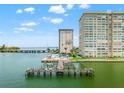 Stunning aerial view of waterfront condos with a pool, boat dock, and bridge access at 5200 Brittany S Dr # 1202, St Petersburg, FL 33715