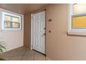 Exterior condo entryway with white door and tile flooring at 5200 Brittany S Dr # 1202, St Petersburg, FL 33715