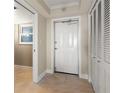 Bright condo entryway with white door and built-in storage at 5200 Brittany S Dr # 1202, St Petersburg, FL 33715