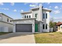 Modern two-story house with green door and gray exterior at 3119 W Cypress St, Tampa, FL 33607