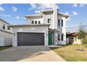 Modern two-story house with green door and gray exterior at 3119 W Cypress St, Tampa, FL 33607