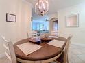 Charming dining area with round table, four chairs, and access to the living room at 2741 Via Cipriani # 931A, Clearwater, FL 33764