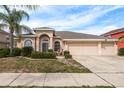 One-story house with a three-car garage and manicured lawn at 12923 Carlington Ln, Riverview, FL 33579
