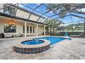 Resort-style pool and spa with covered patio and outdoor kitchen at 4114 W Zelar St, Tampa, FL 33629