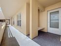 Exterior building walkway featuring exterior door, bench, and corridor with windows at 4410 Fairways Blvd Blvd # 607, Bradenton, FL 34209