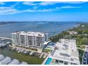 Stunning aerial view of waterfront condominium with boat slips and panoramic ocean views on a sunny day at 920 N Osceola Ave # 401, Clearwater, FL 33755