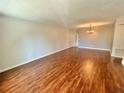 Spacious living room featuring hardwood floors and a chandelier at 2360 World Parkway Blvd # 54, Clearwater, FL 33763