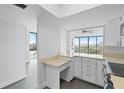Modern kitchen with white cabinets, stainless steel appliances, and tile flooring at 500 N Osceola Ave # 802, Clearwater, FL 33755