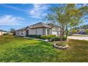 Side view showcasing the home's exterior and landscaping at 13285 Crest Lake Dr, Hudson, FL 34669